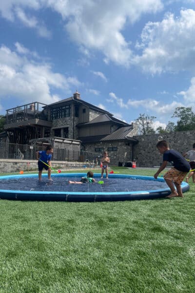 Children enjoying some water games on the great lawn
