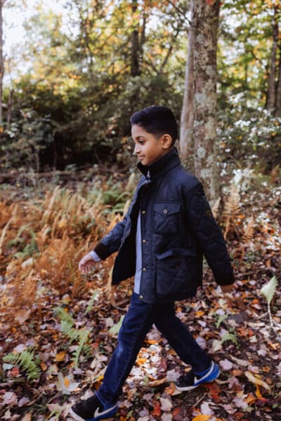 A young adolescent is taking a walk in the fall on the Turkey Wilderness Trail.